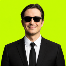 Agent Vlad, a trader in a black suit, black tie and sunglasses against chartreuse